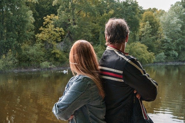 Father and daughter at a lake