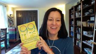 Karen holds a copy of 99 Tips and smiles broadly.