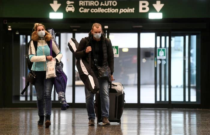 People wearing protective masks at Malpensa airport near Milan, March 9.