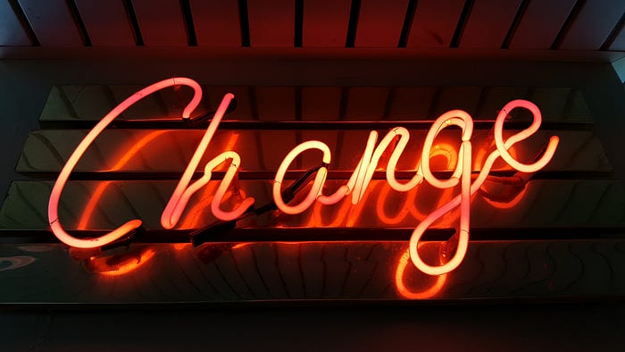 Neon sign reading “change.”