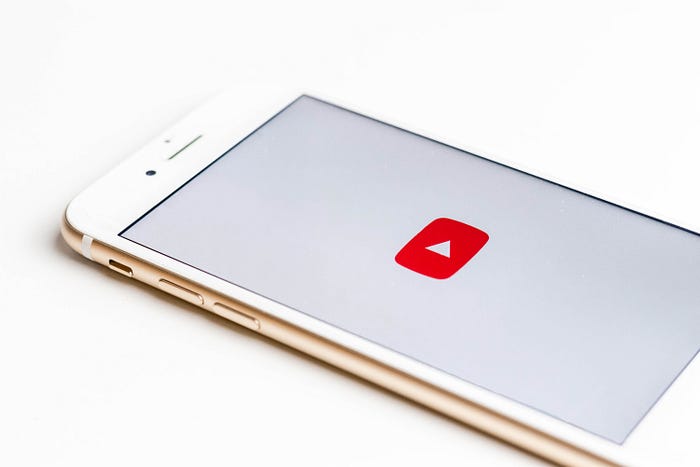 Smartphone with YouTube logo displayed on screen