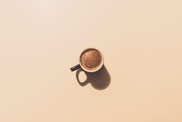 a mug of coffee on a beige background