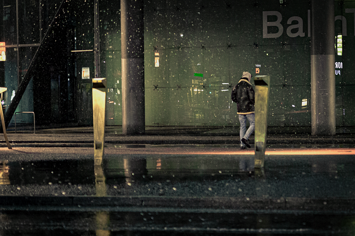 Man walking across Potsdamer Platz in Snowy weather