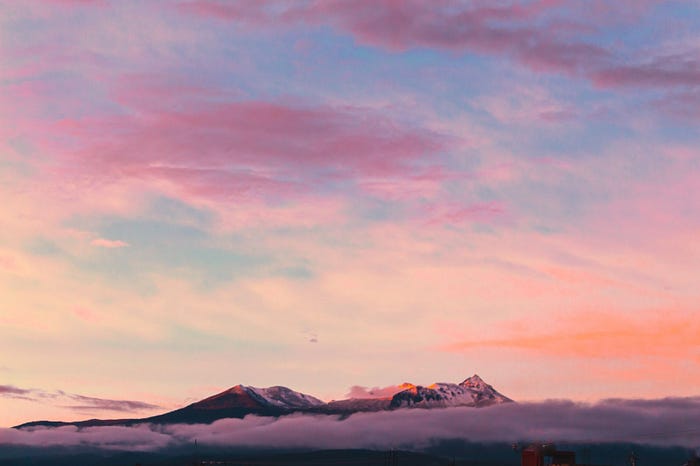 beautiful mountain peaks above the clouds during sunset