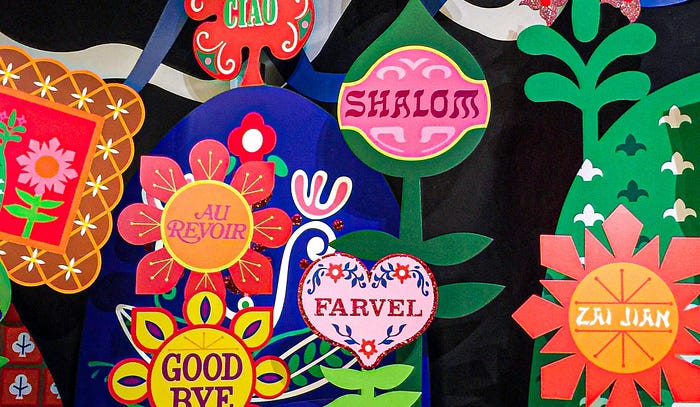 A collection of colorful paper signs with ‘Good Bye’ written in different languages