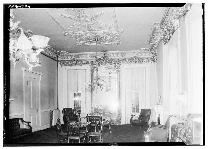A black-and-white photograph of a vintage ballroom.