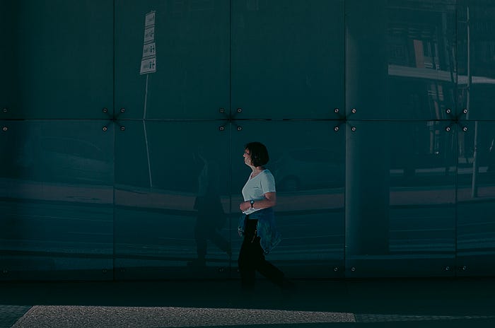 Woman walking under cover in a Berlin Street