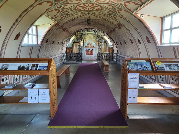 Interior of the beautiful chapel. Showing pews, aisle, and alter.