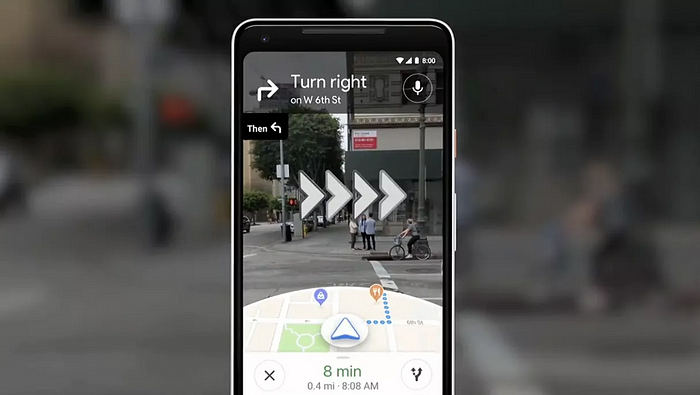 The image depicts the AR possibilities of Google street view. Showing the way to go through the camera on the phone.