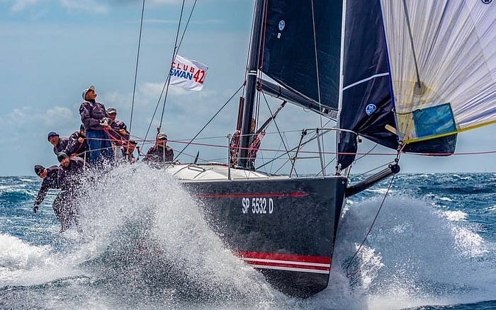 sailboat going through a wave
