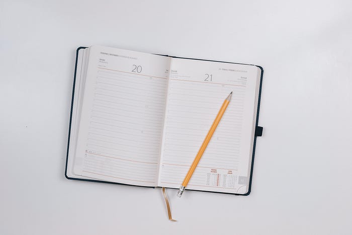 Schedule/planner open with a pencil on it