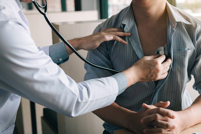 Doctor listening to heartbeat with stethoscope