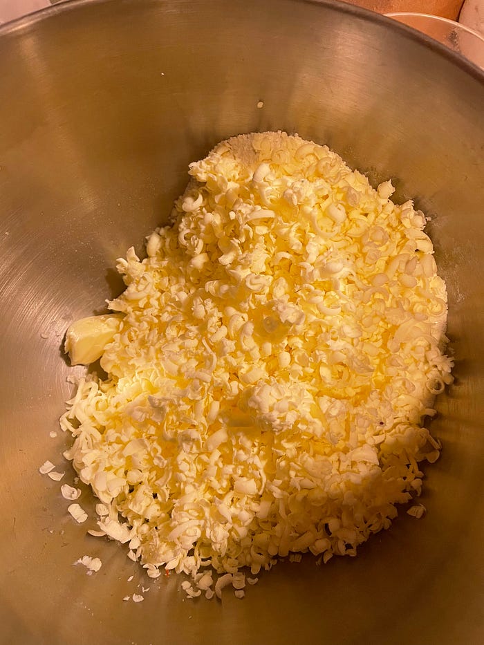 A mixing bowl with grated butter inside.