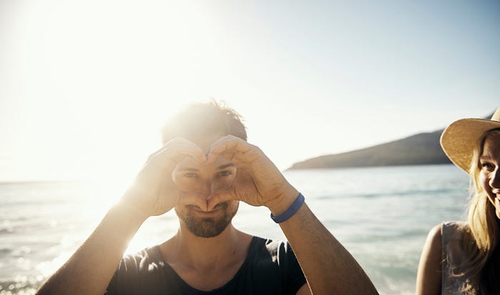 Man making heart with his hands.