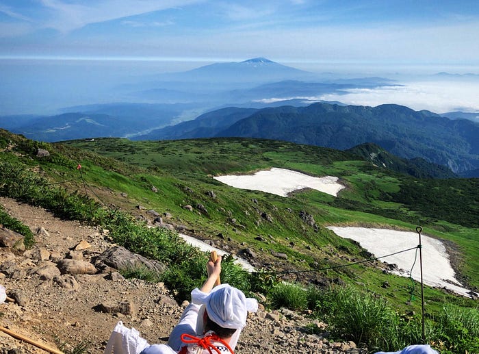 During Yamabushi training on Mt. Gassan of the Dewa Sanzan, Tim Bunting AKA the Kiwi Yamabushi stares intently at Mt. Chokai as it pokes its head through the clouds in the distance.