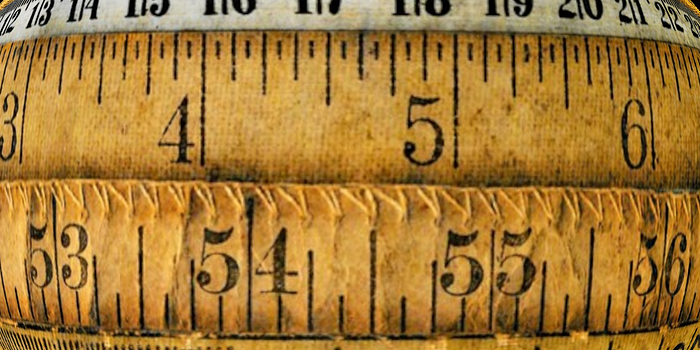 Several rows of old rulers and yardsticks, distorted as through a lens.