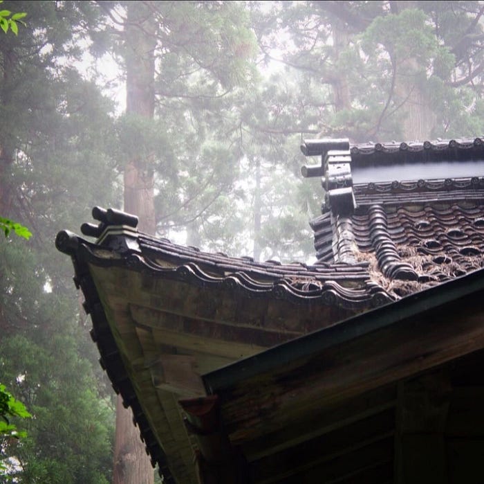 The tiled roof of Yakushi Shrine stands out against the cedar forest at the base of Mt. Kumanonagamine, one of the 100 Famous Mountains of Yamagata in Tohoku, north Japan.