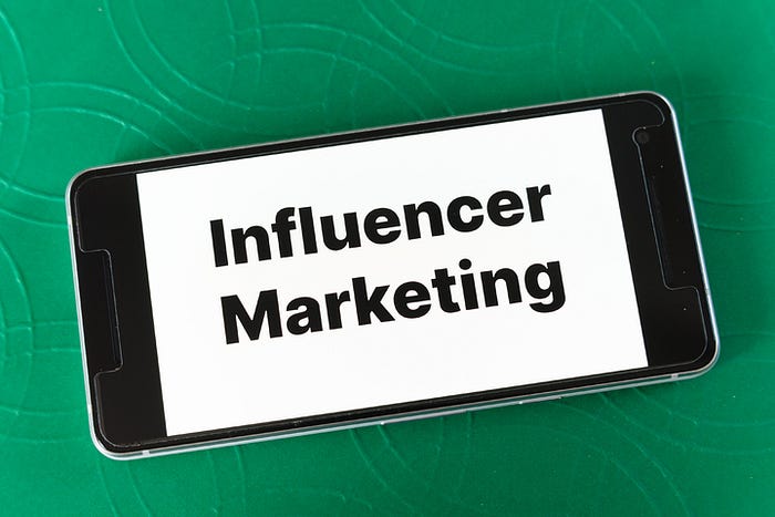 smartphone with the words influencer marketing on the screen