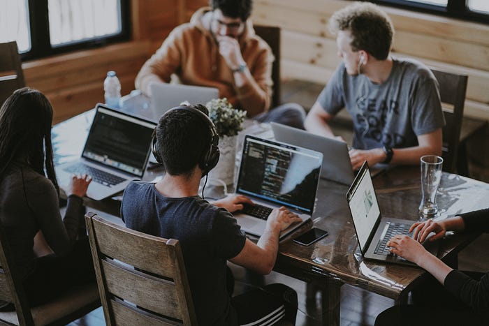 People working on computers at a table