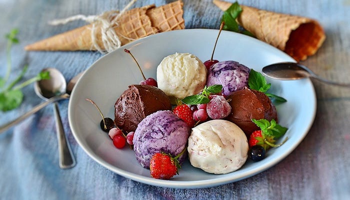 ice cream scoops with cherries and strawberries