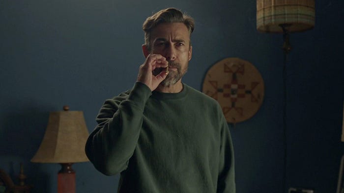 Ronny taking a pull of a joint as he stares at intimidatingly at Barry