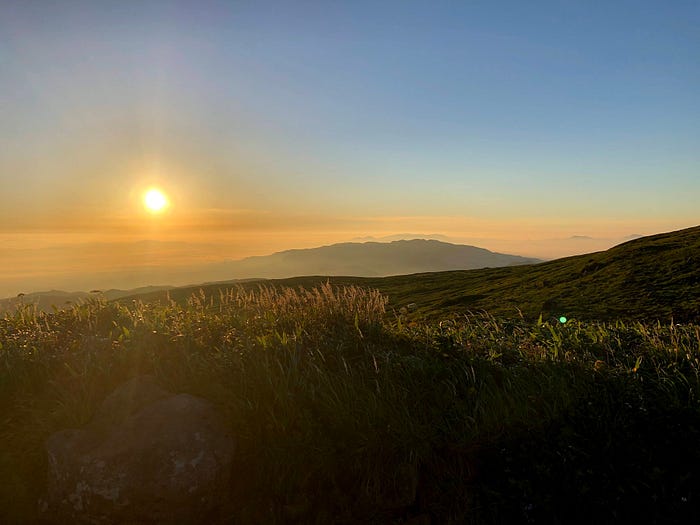 The sun rises over the mountains surrounding Mt. Gassan of the Dewa Sanzan