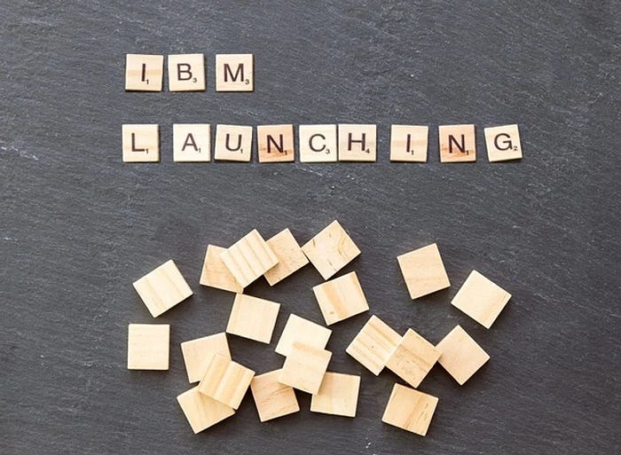 Wooden cubes spelling out 'IBM LAUNCHING'