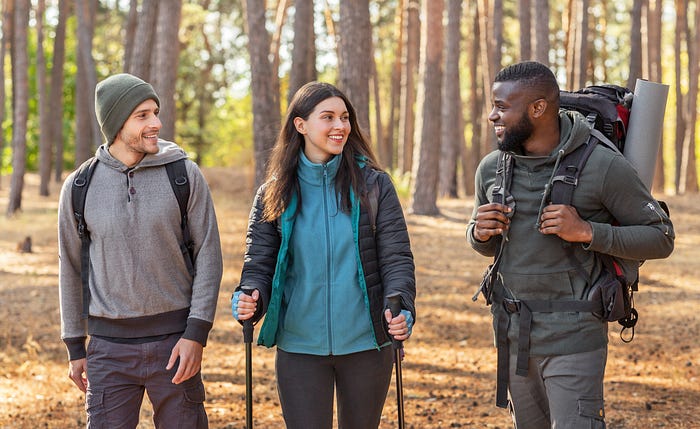 Multiracial group of hikers taking in woods during the fall, outdoor lifestyle for all, Multicultural Outdoor Adventure, Diverse Outdoor Community, Inclusive Outdoor Recreation