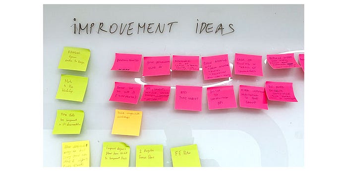 Improvement ideas written on sticky notes are listed on a white dashboard