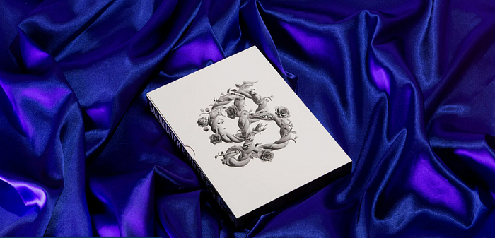 Sagmeister and Walsh’s book, “Beauty”, on a purple velvety fabric