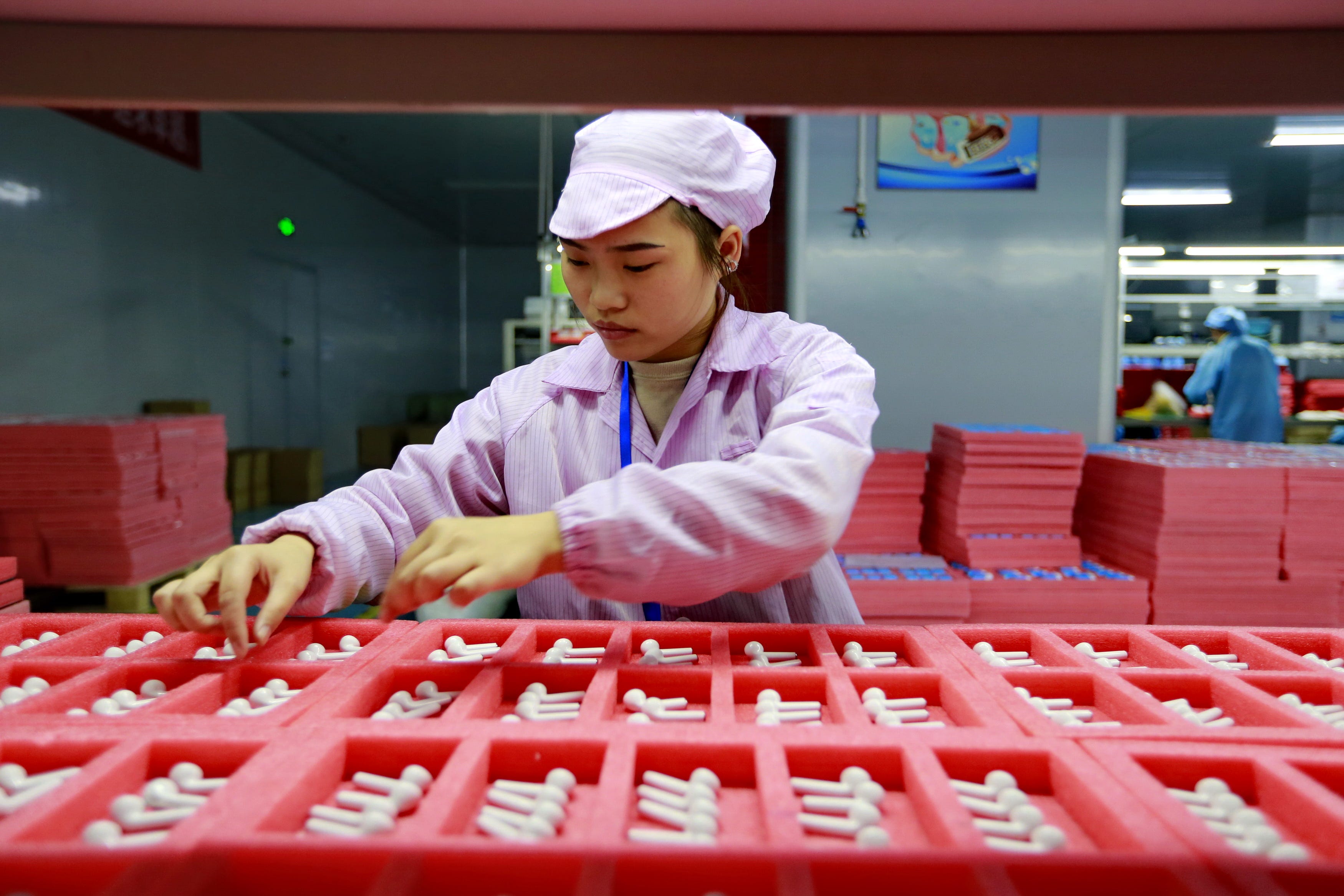 A woman worker assembles earphones for export in a factory in Suining in southwest China’s Sichuan province on Dec. 17, 2019.
