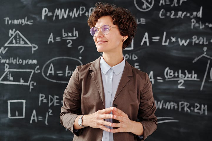 woman in front of chalk board