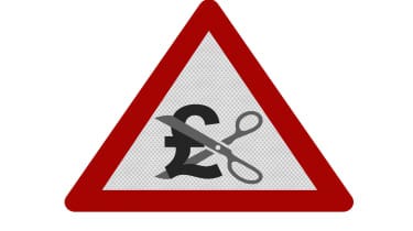 A red triangular warning sign with scissors cutting a pound symbol in half