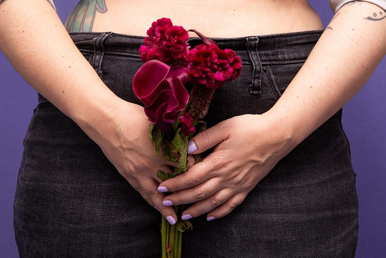 An individual holding a flower.