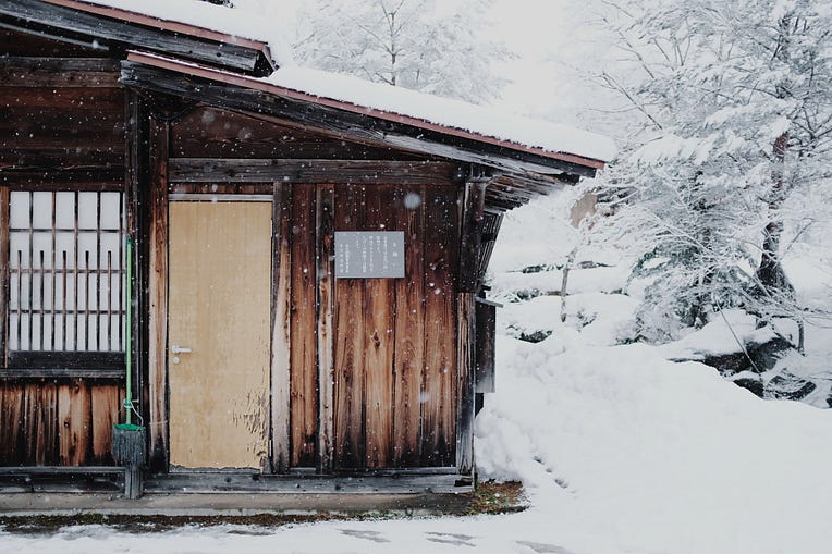 A photo of an old hut in the winter