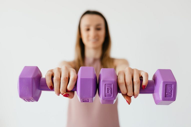 Women lifting purple weights