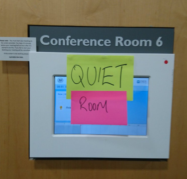 Photo saying 'conference room 6' with post-it notes stuck on it saying Quiet Room