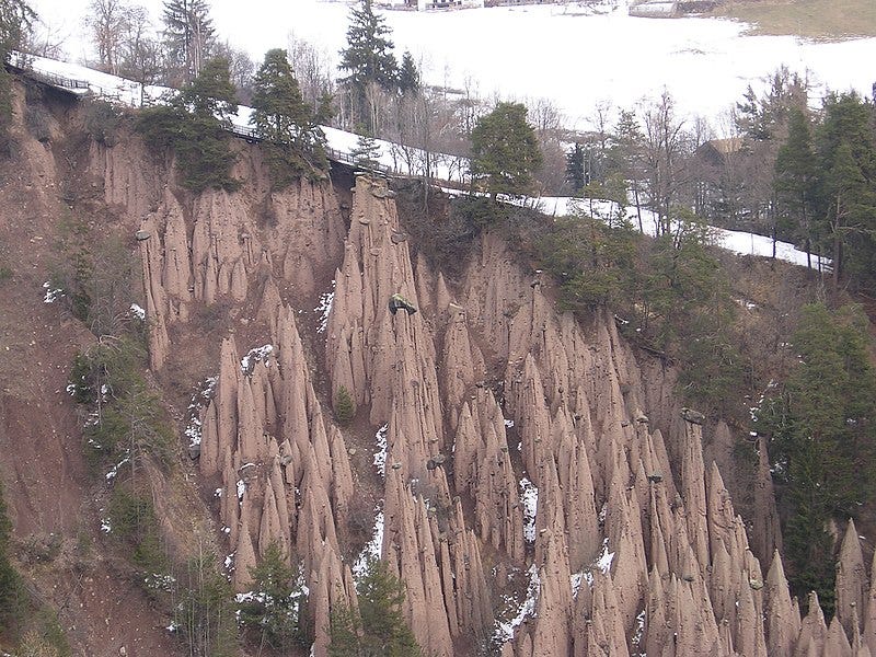 The Ritten Earth Pillars, Italy. A wooded ravine in Northern Italy ...