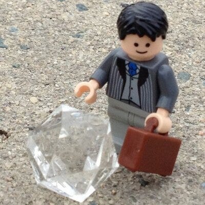 A LEGO businessman with a D20 dice