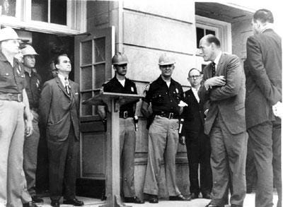 Governor George Wallace of Alabama is blocking the schoolhouse door at the University of Alabama to prevent integration. 1963