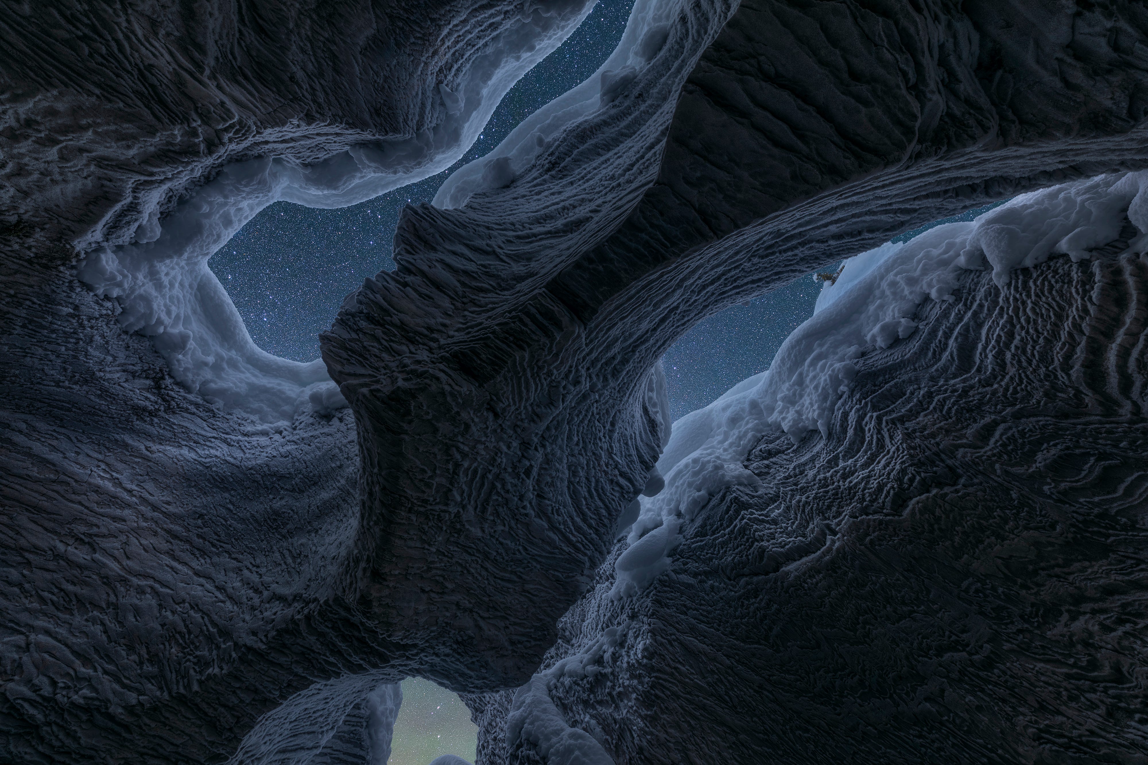 A night-lit shot of the Rocky Mountains, showing a cave texture that looks like water or art