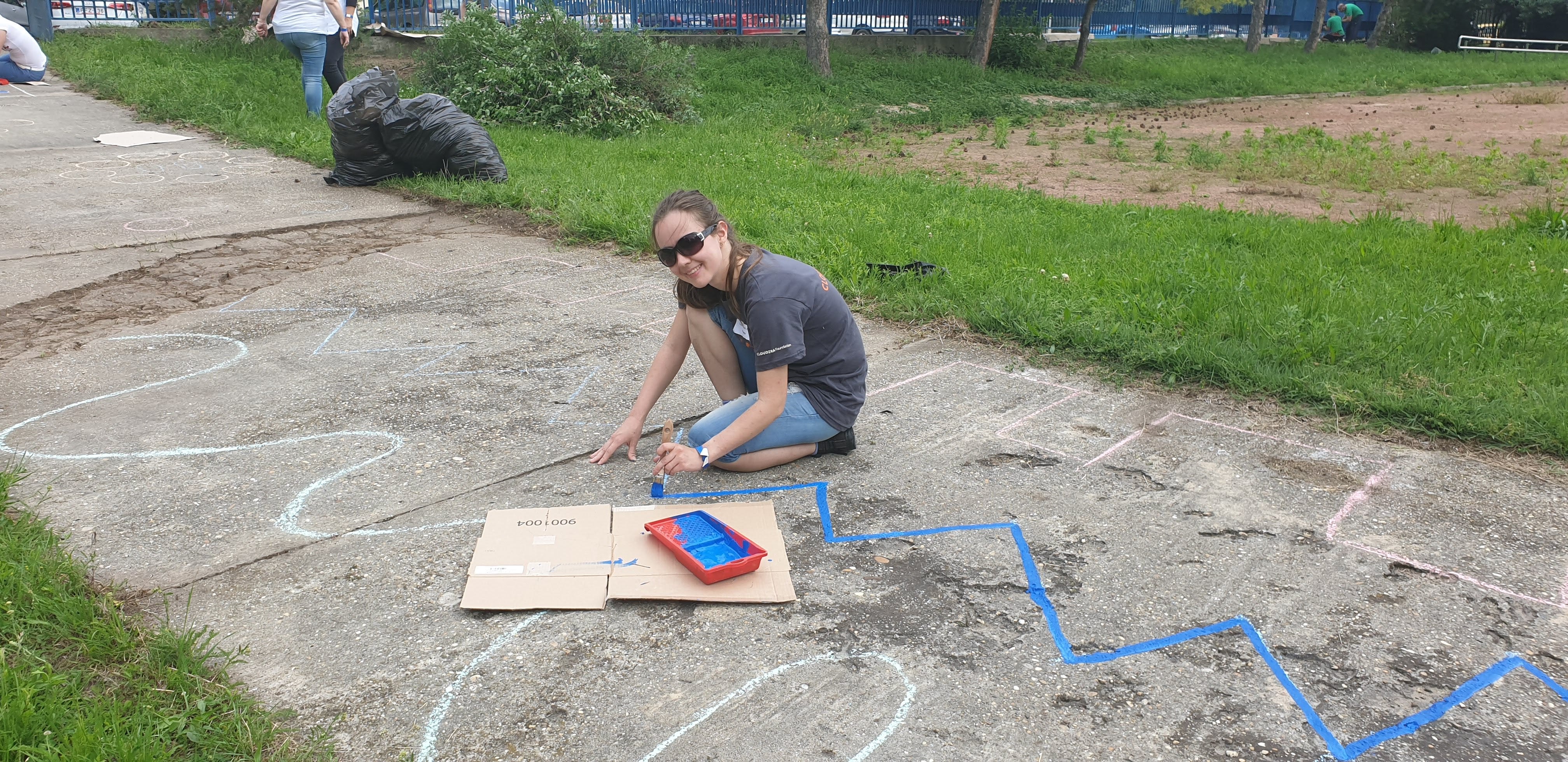 woman painting game on sidewalk