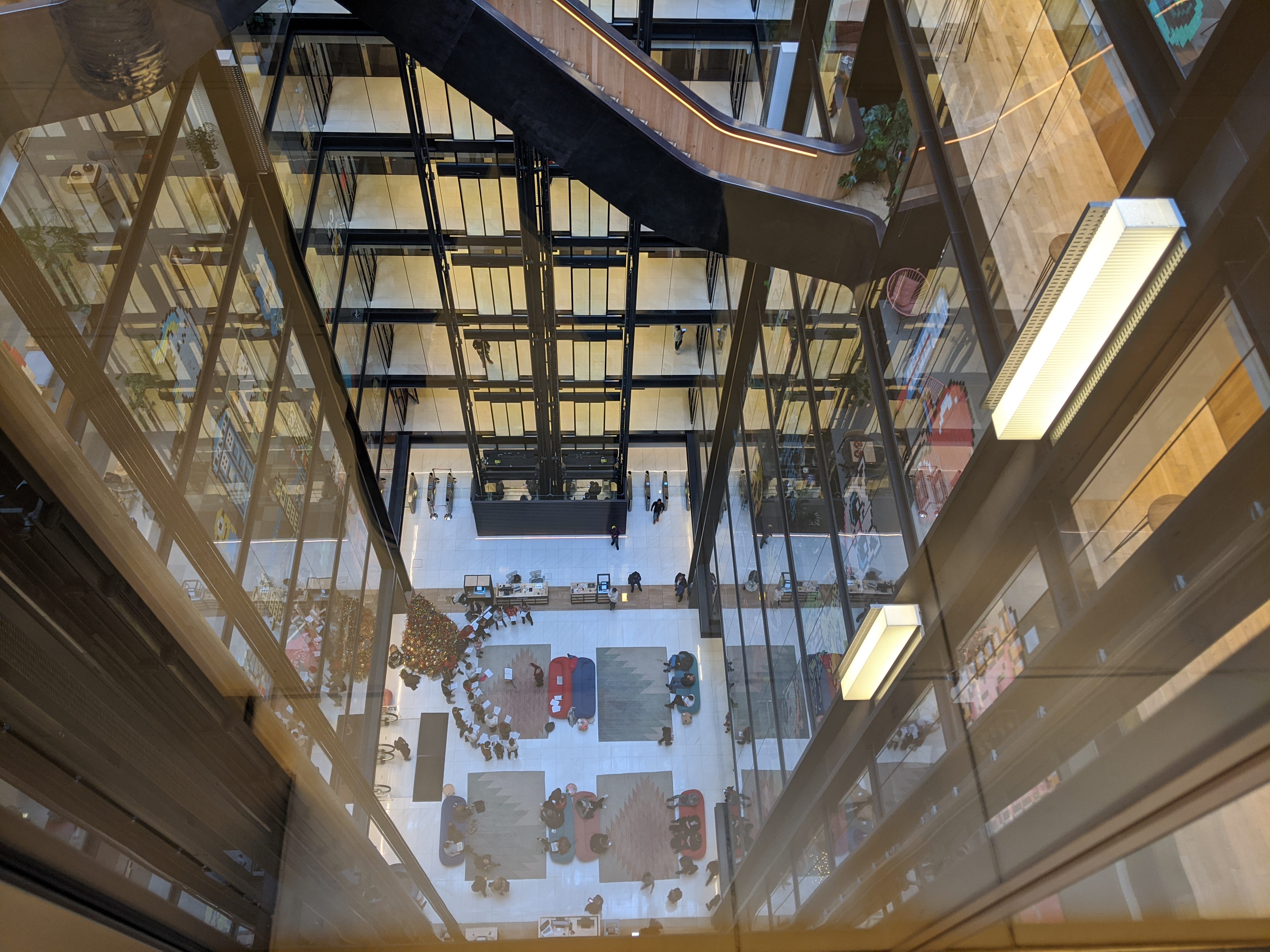 Looking down 7 floors to a lobby through an elevator.