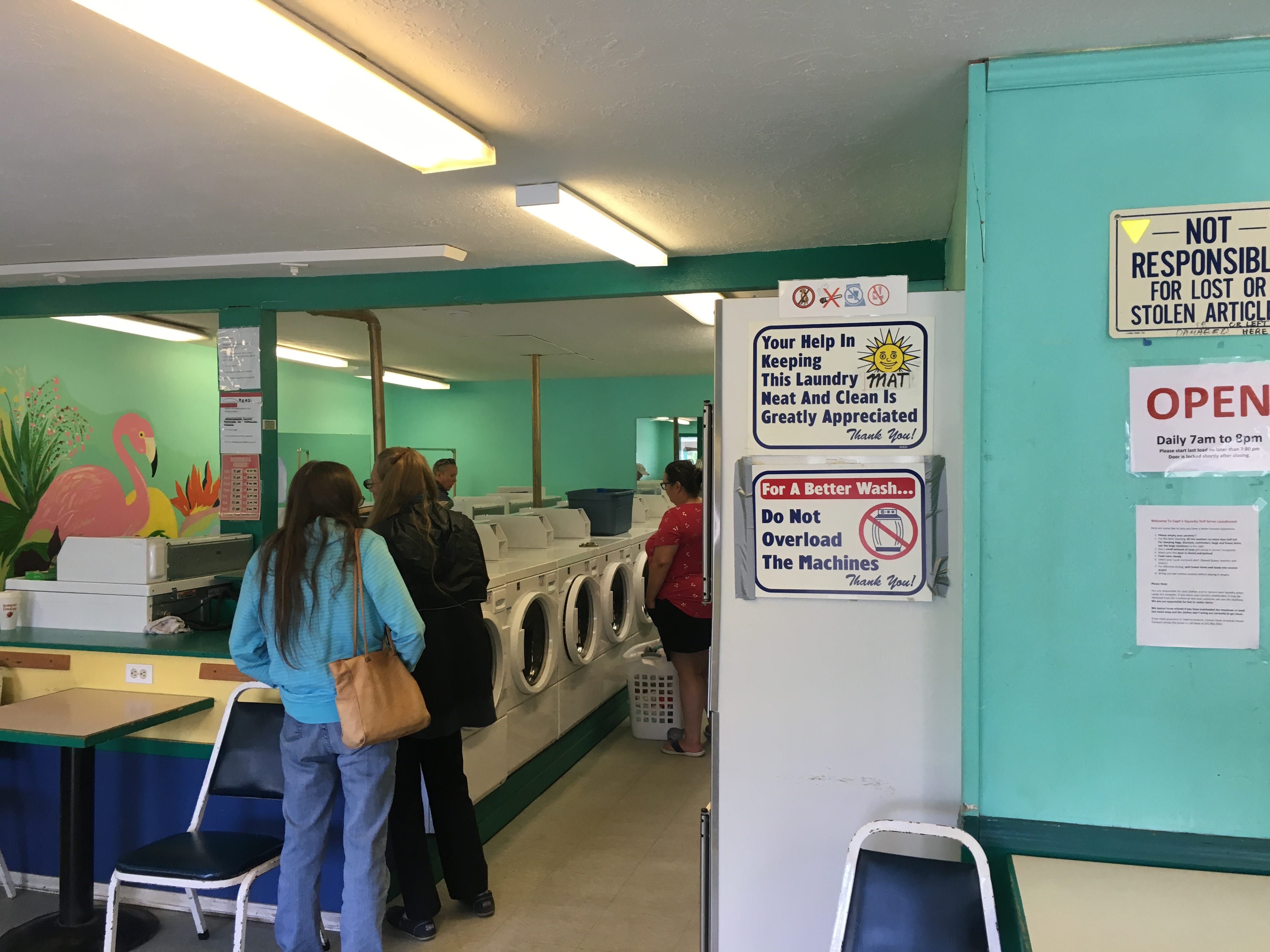 a laundromat with seafoam green walls