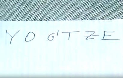 a photo of a piece of lined paper. on it is written Y O G’ T Z E in clean handwriting