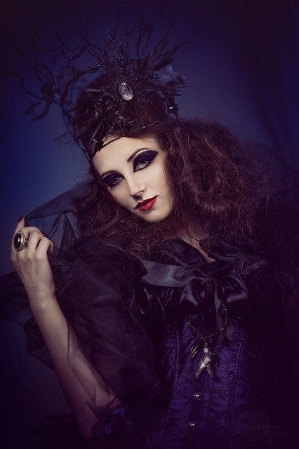 Woman dressed in a black ball gown and veil