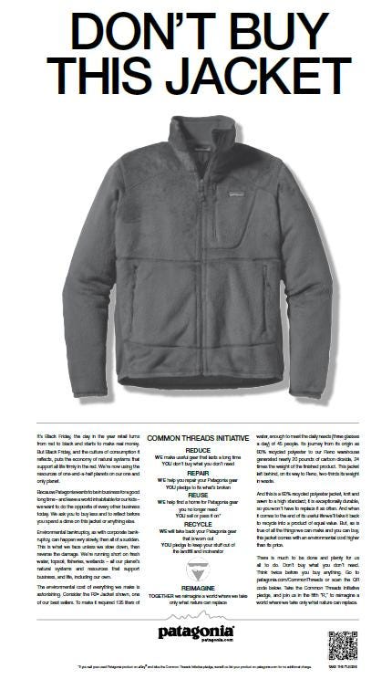 The image  shows the ad “Don’t buy this jacket” , published on the Friday, November 25th, 2011 edition of New York Times. It’s a white page that shows at the top the title “Don’t buy this jacket”, under it a no background image of a big grey coat and at the bottom a text explaining the ad’s message.
