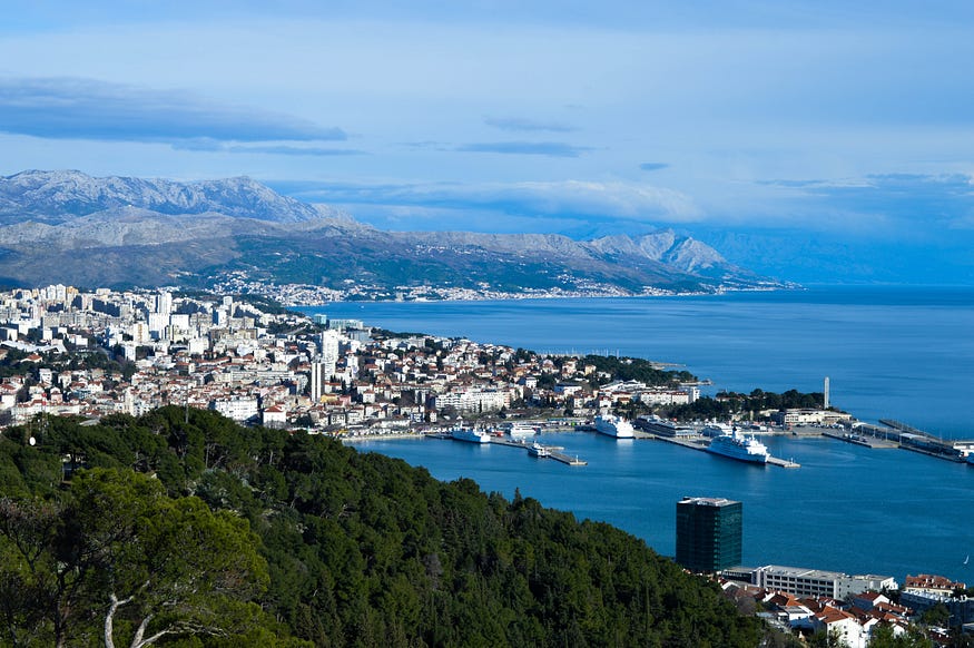 Image shows the view from Marjan Hill looking over Split city with mountains in the background.