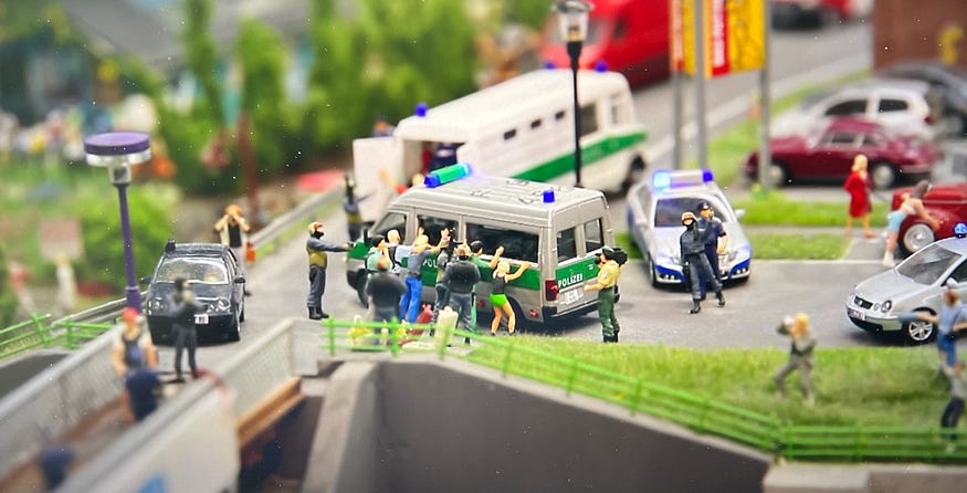 A realistic crime scene in a model railroad showing attention to detail.