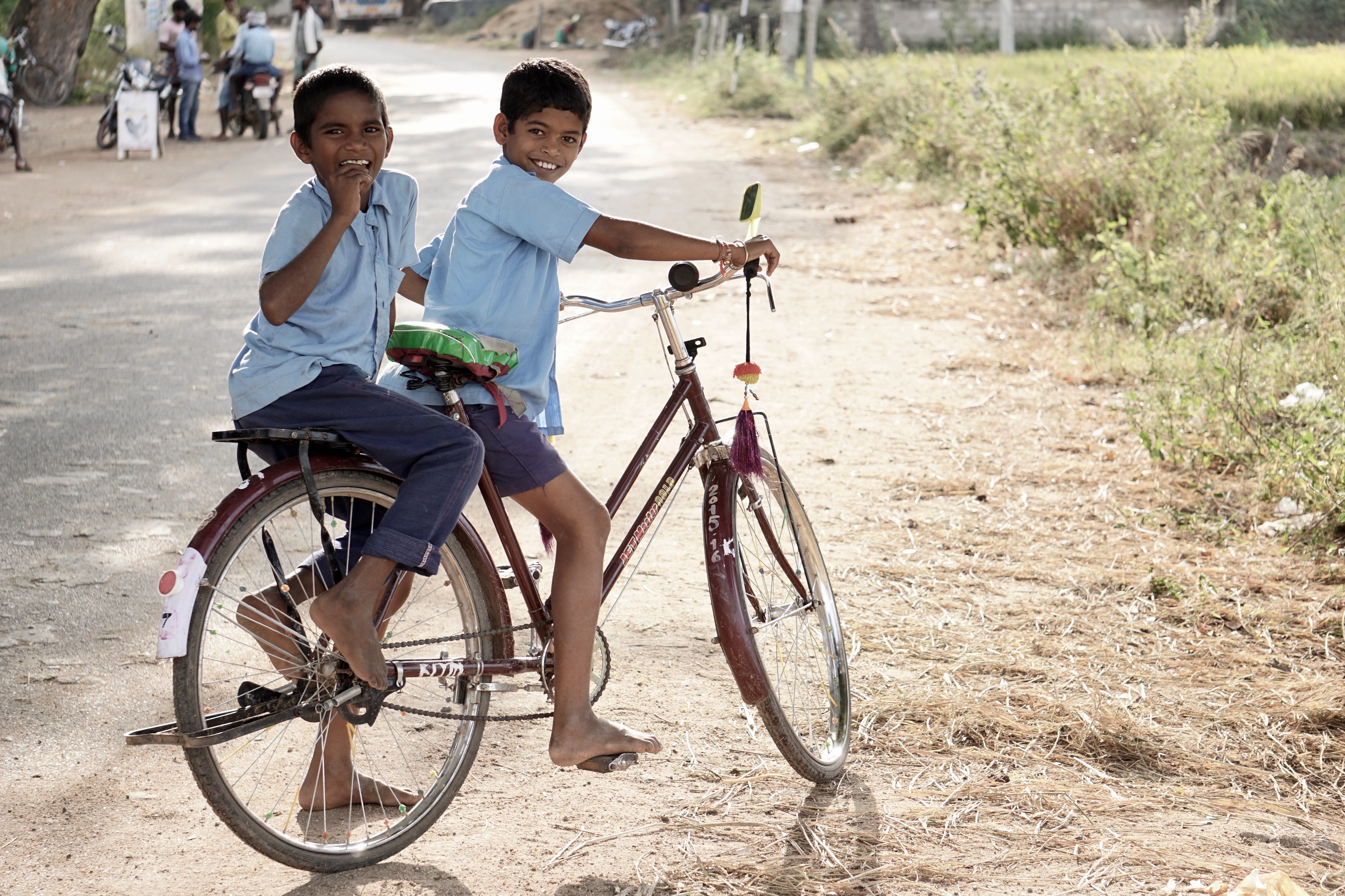 Photography of 2 kids on a bike